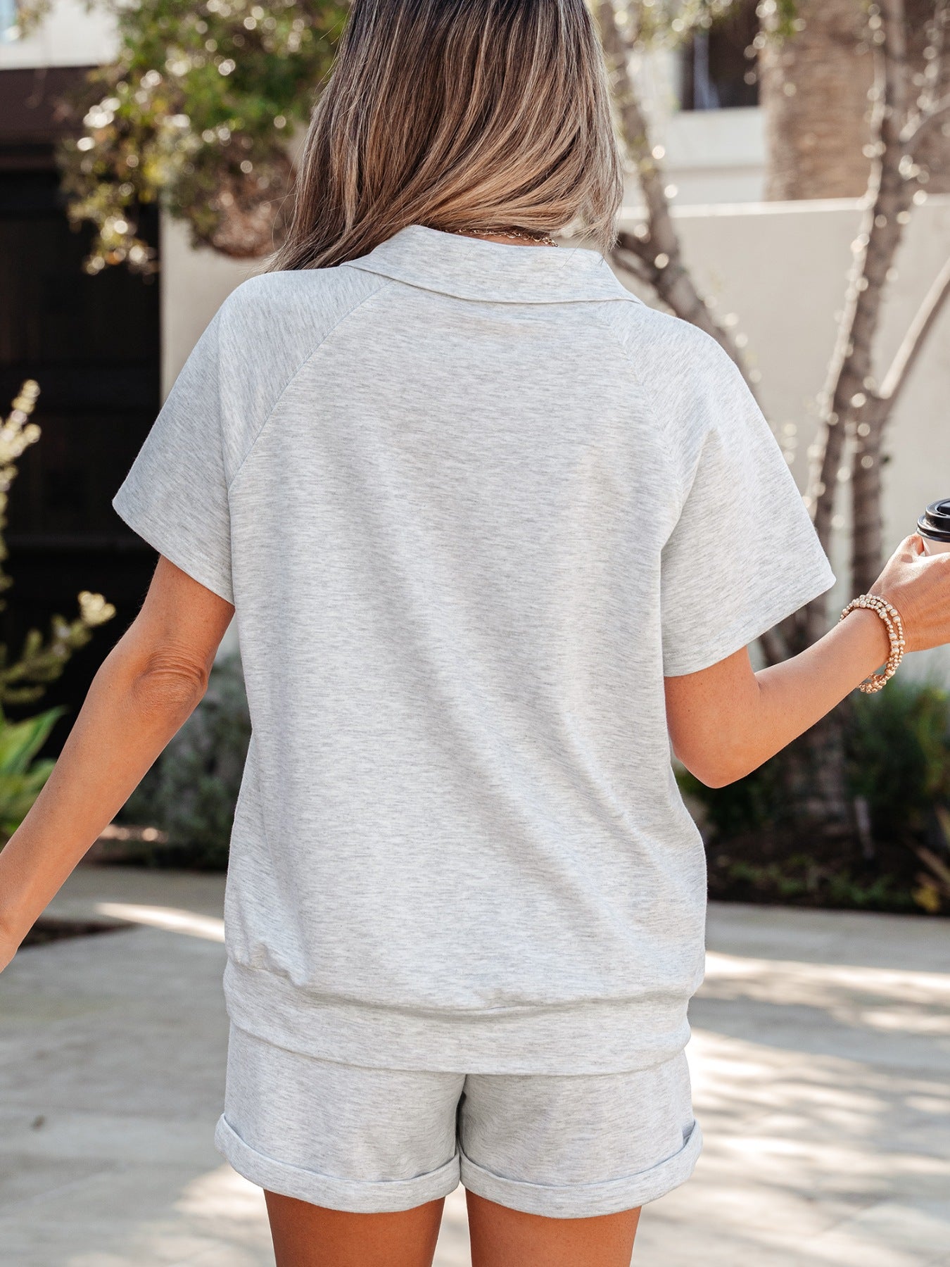 Light grey polo collar loungewear set with short sleeves and cuffed shorts.