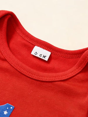 Red baby outfit with patriotic star detail and care tag.