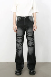 Distressed flare denim jeans in dark shadow wash with a bootcut leg.