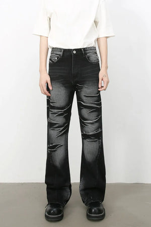 Distressed flare denim jeans in dark shadow wash with a bootcut leg.