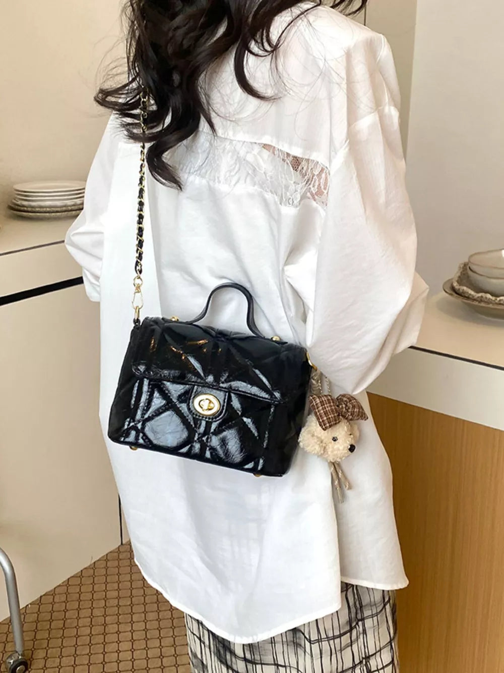 Black crossbody bag with turn-lock and quilted