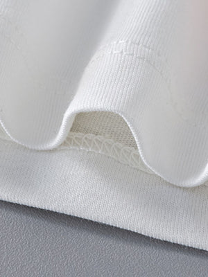 White cotton toddler t-shirt detail showing crew neck stitching and hem.