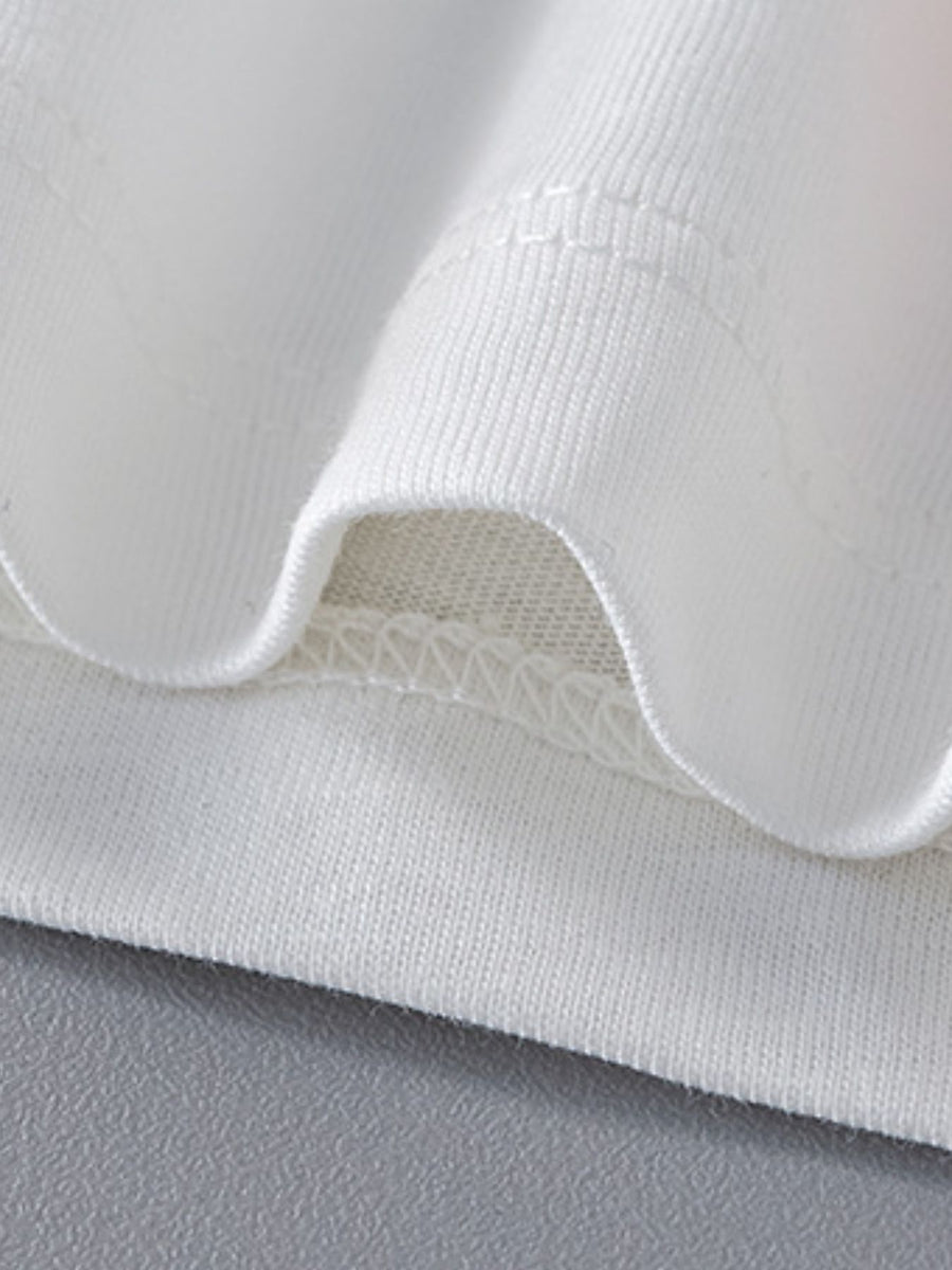 White cotton toddler t-shirt detail showing crew neck stitching and hem.