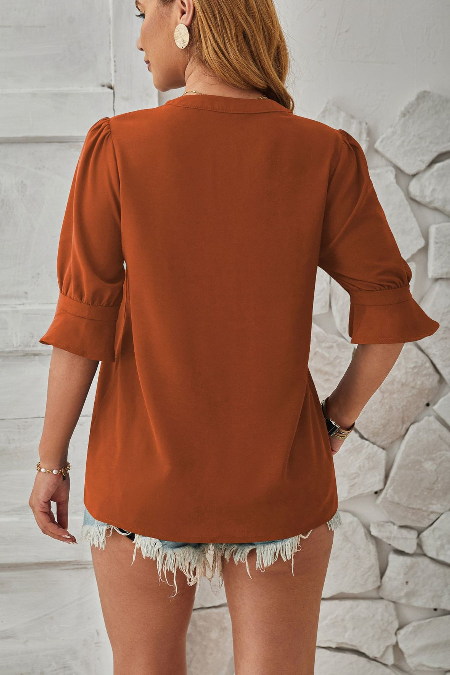 Brown puffed sleeve blouse with flared cuffs and a relaxed fit.