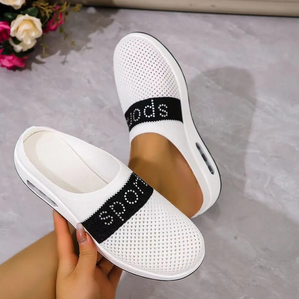 White mesh sportswear mules with air cushion and black "sport" band detail