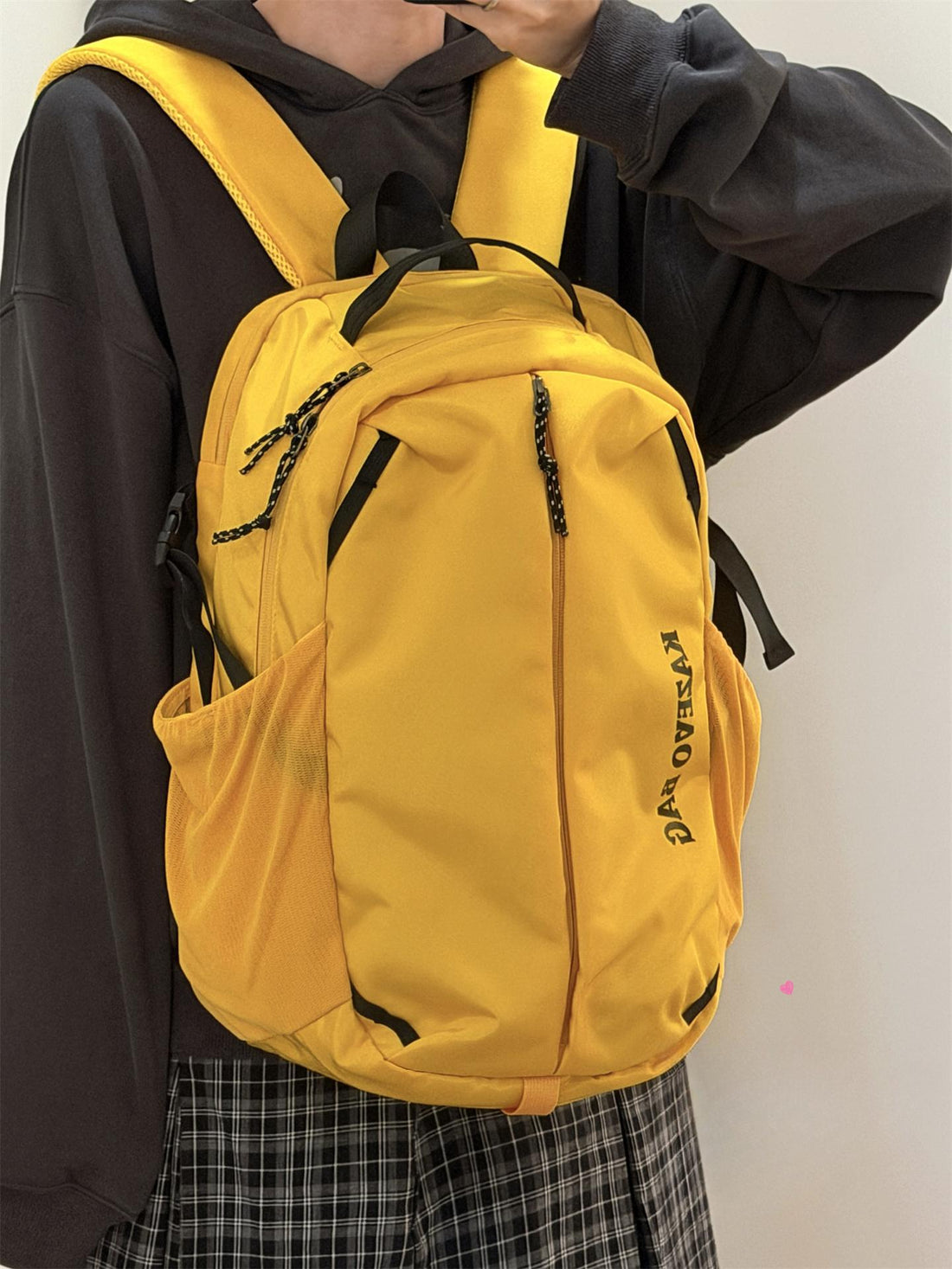 Yellow nylon casual backpack with black accents and side mesh pocket.