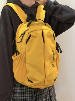 Yellow nylon casual backpack with black accents and side mesh pocket.
