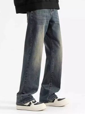 Men's relaxed fit jeans in heritage wash denim with a faded look.