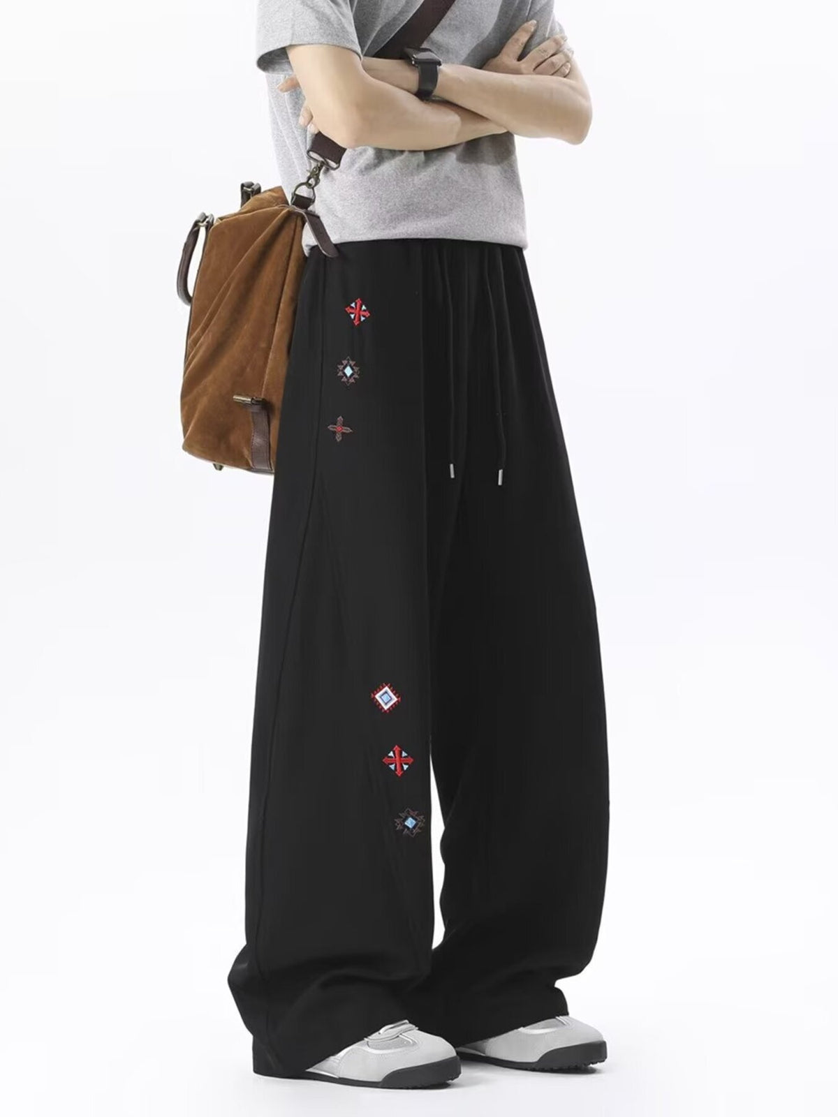 White wide-leg pants featuring embroidered and geometric