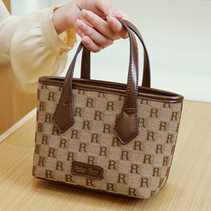 crossbody bag in dark brown with monogram and top handles