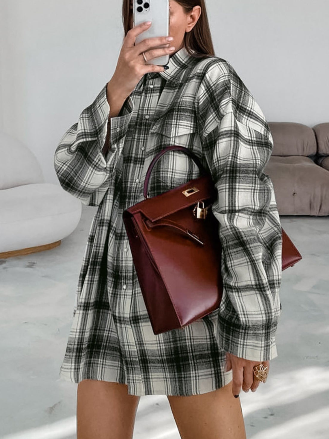 Button-up long sleeve cotton shirt dress in black and white plaid with pearl details.