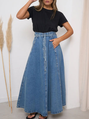 High-waisted A-line denim skirt in light blue with a tie belt and pockets.
