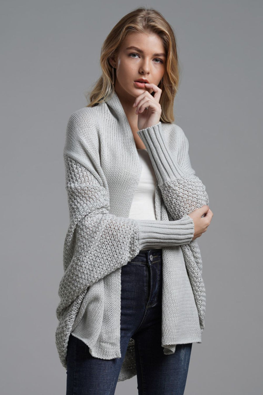 Gray batwing knit cardigan with drape front and textured sleeves.