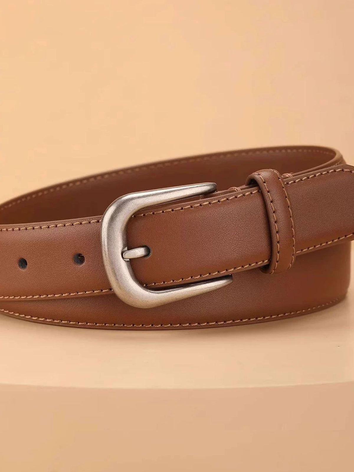 Brown cowhide leather belt with silver buckle and contrast stitching.
