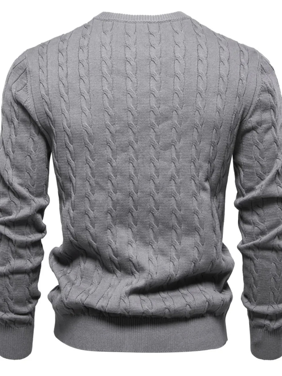 Gray cable knit crewneck sweater with ribbed cuffs and hem