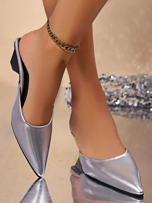 Silver kitten heel mules with pointed toe and chain anklet.