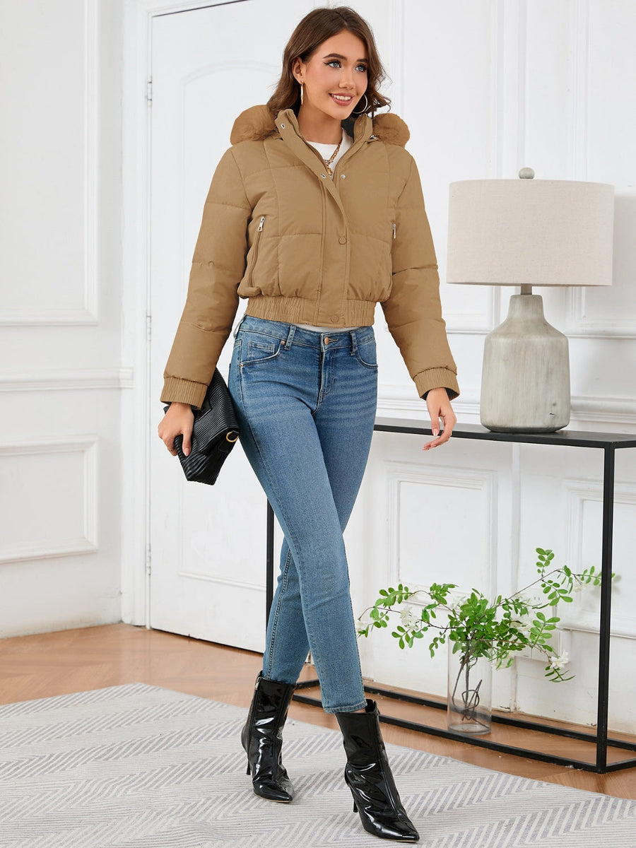 Camel puffer jacket with faux fur trim, cropped length, and zippered pockets.