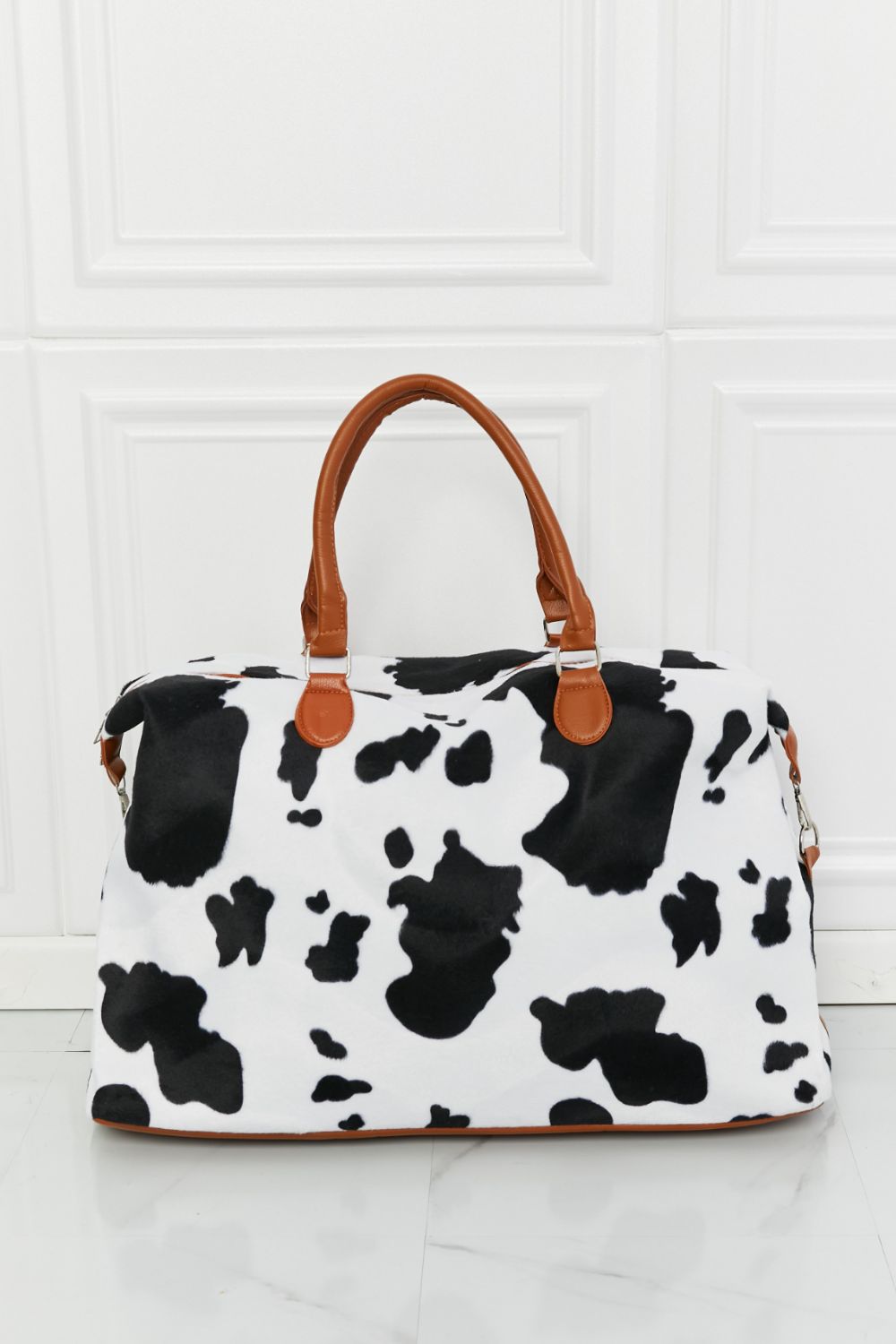 Cowhide print duffel bag with brown leather handles