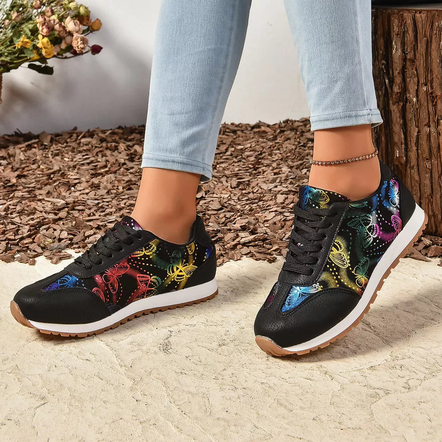 Black casual sneakers with a vibrant rainbow butterfly print and white soles.