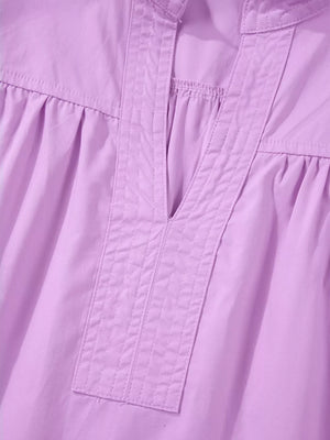 Purple cotton shirt with notched V-neck and pintuck detail.