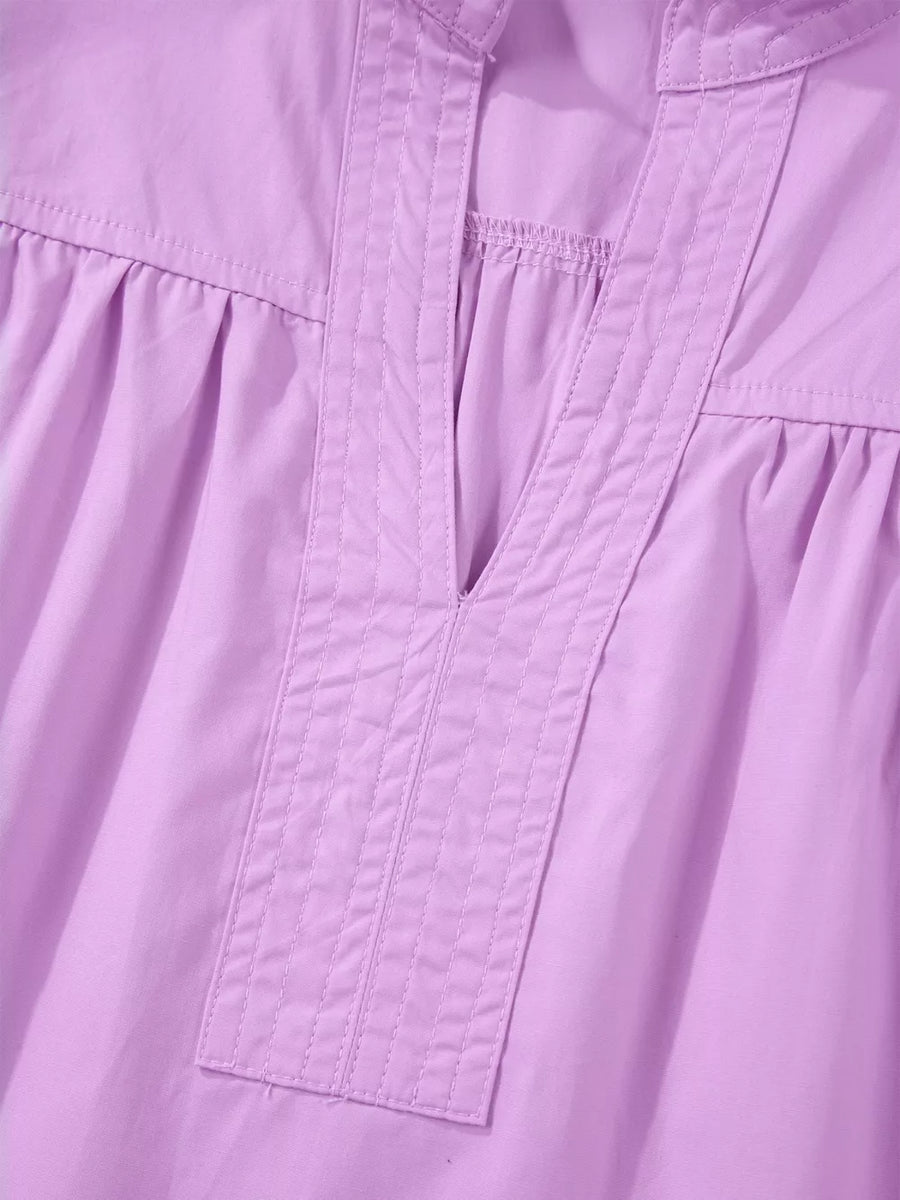 Purple cotton shirt with notched V-neck and pintuck detail.