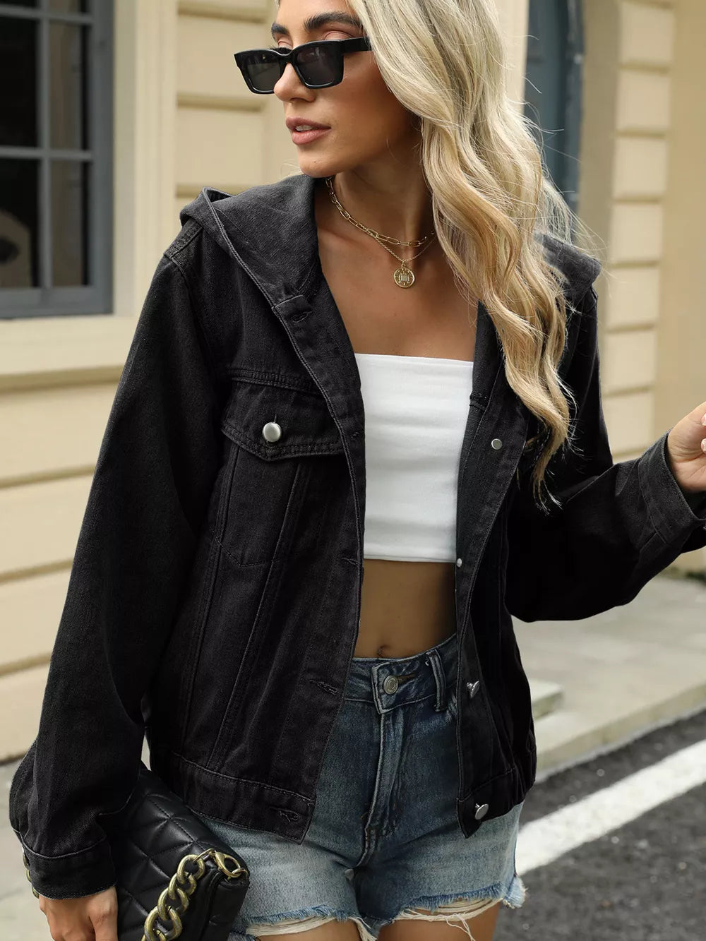 Black hooded denim trucker jacket with chest pockets and button-up front.