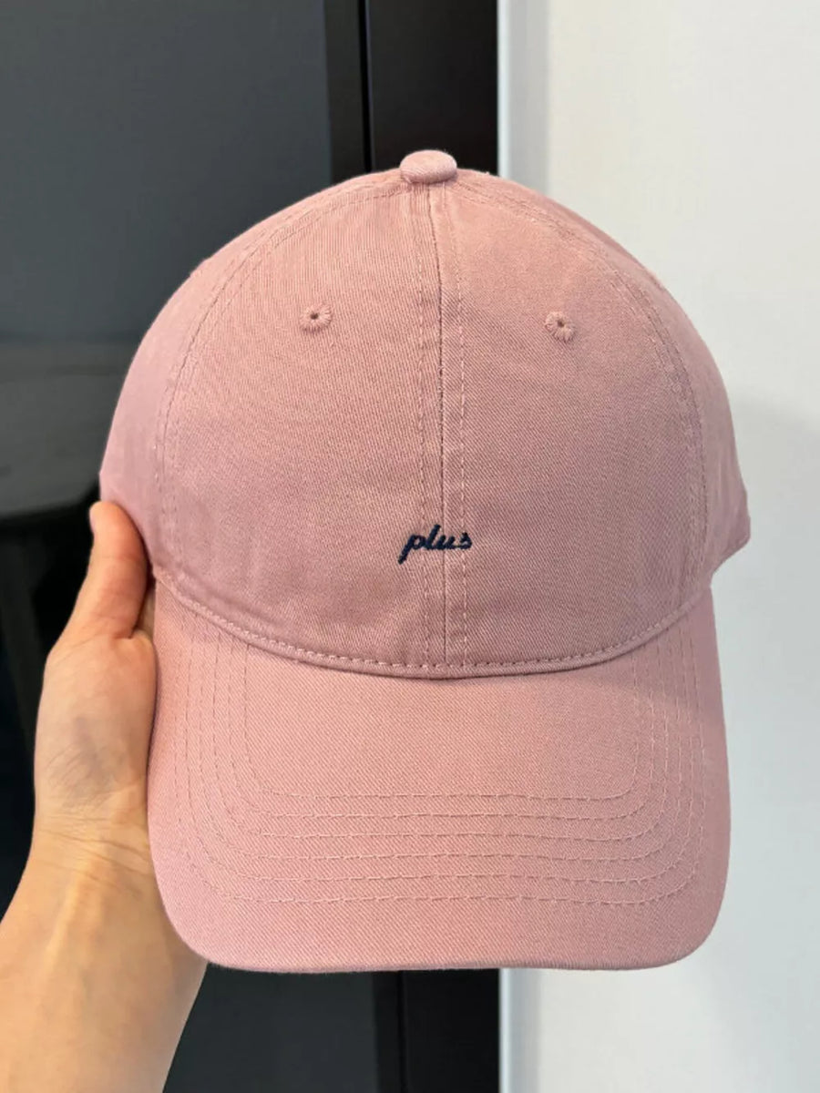Pink baseball cap with embroidered "plus" detail