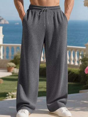 Men's dark gray ribbed drawstring sweatpants with a relaxed fit.