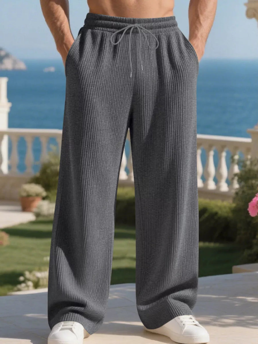 Men's dark gray ribbed drawstring sweatpants with a relaxed fit.
