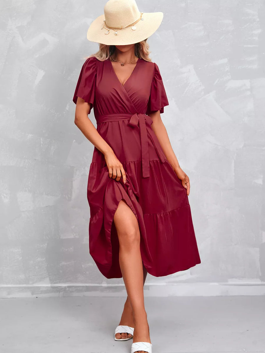 Scarlet flutter sleeve tiered midi dress with wrap neckline and belted waist.