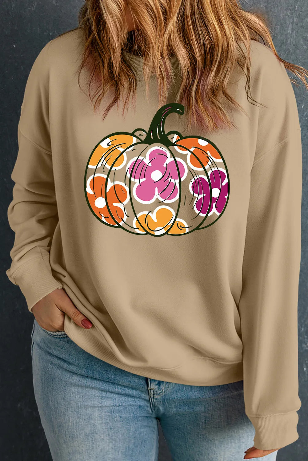 Khaki crewneck sweatshirt with a colorful floral pumpkin graphic.