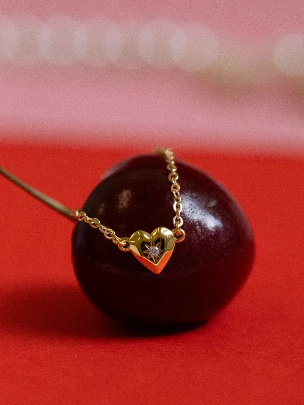 Gold heart pendant necklace with diamond accent on delicate chain