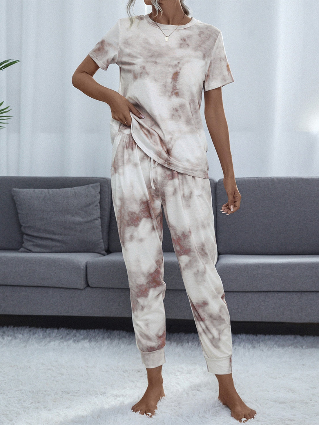 Multicolor tie-dye loungewear set with short sleeve top and drawstring pants.