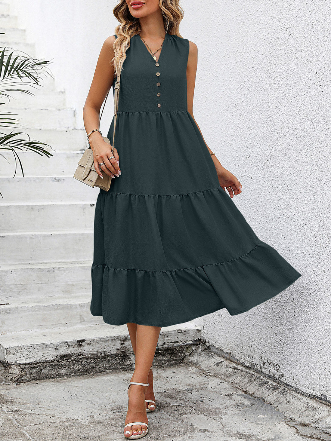 Dark green sleeveless midi dress with button-down front and tiered ruffles.