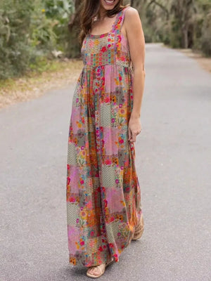 Vibrant patchwork wide-leg romper with floral print and square neckline.