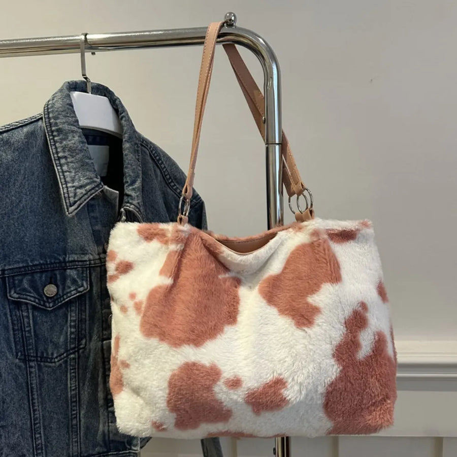Dusty pink cowhide print faux fur shopper bag with tan straps.