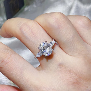 ring in silver featuring 3 carat moissanite and three-stone oval with pear accents fit