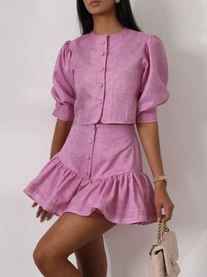 Pink linen blend crop top with puff sleeves and matching ruffled mini skirt.