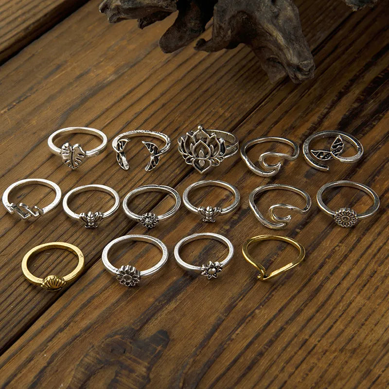 Silver and gold alloy rings with botanical and sculptural designs, including lotus and leaf motifs.