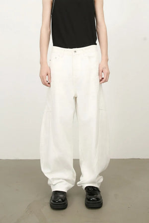 White wide leg trousers with sculpted pocket details and a relaxed fit.