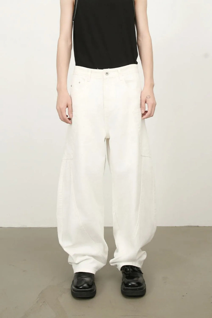 White wide leg trousers with sculpted pocket details and a relaxed fit.