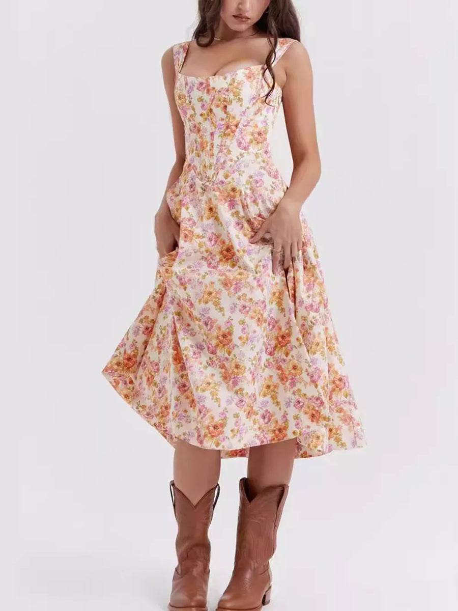 Floral midi dress with side slit in a light pink floral print, featuring a sweetheart neckline and pockets.