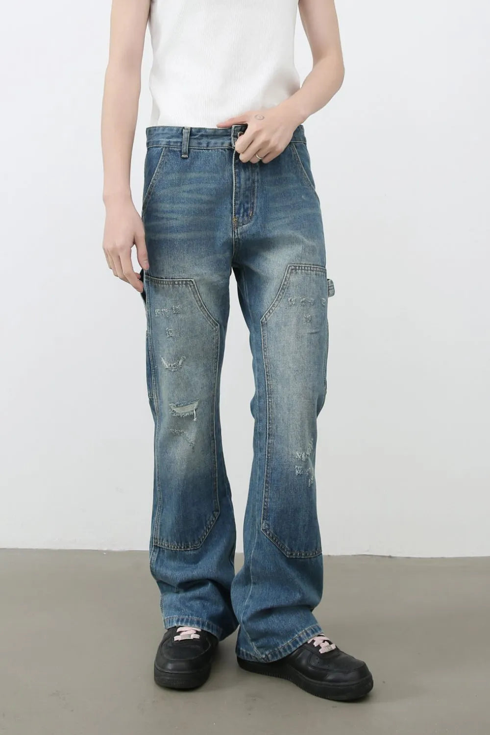 Carpenter flare jeans in medium wash denim with distressed details and a relaxed fit.