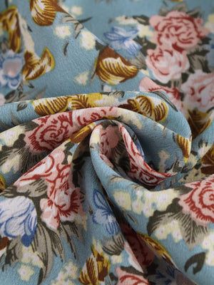 Vibrant floral print mini dress with a deep V-neck and halter neckline.