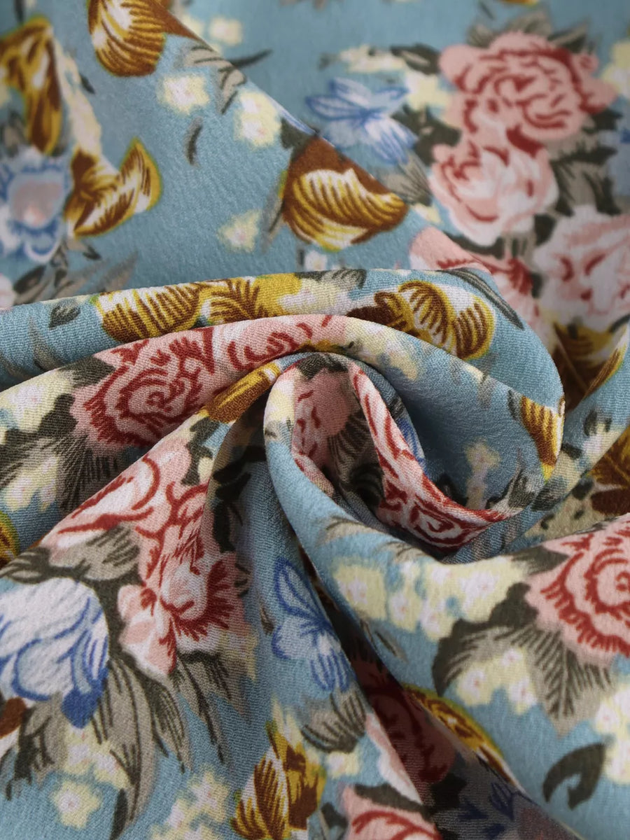 Vibrant floral print mini dress with a deep V-neck and halter neckline.