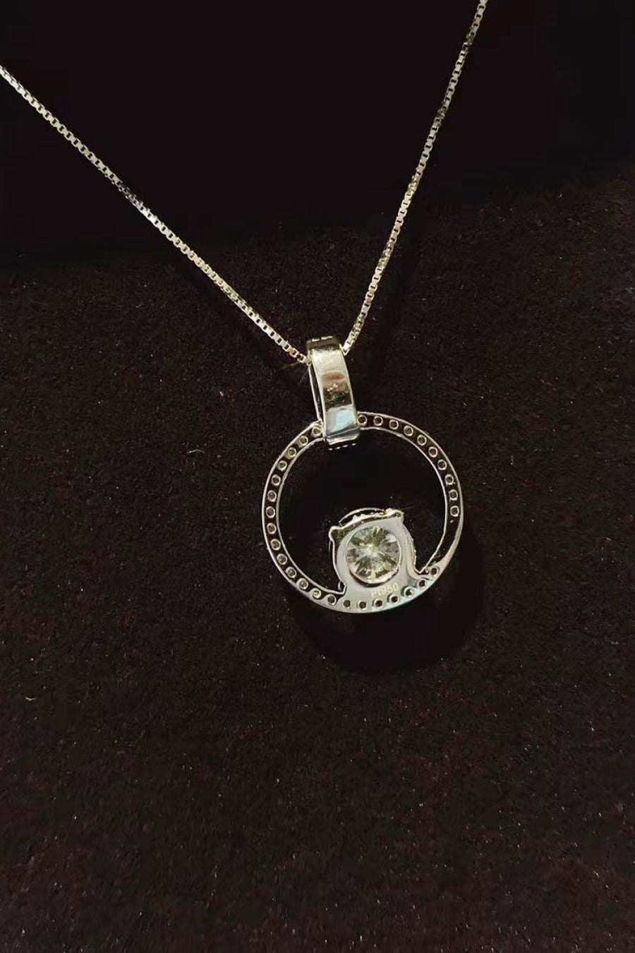 Silver moissanite halo circle pendant necklace on a box chain, made of 925 sterling silver.