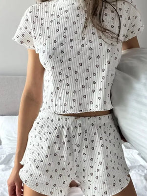 White ribbed lounge set with black heart print, short sleeve top and shorts.