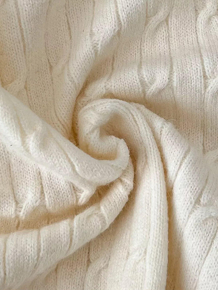 Chic cable-knit cropped cardigan in apricot acrylic fabric with textured detail.