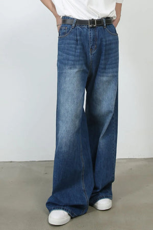 Pleated-front wide-leg denim trousers in peacock blue, featuring a relaxed fit and casual styling.