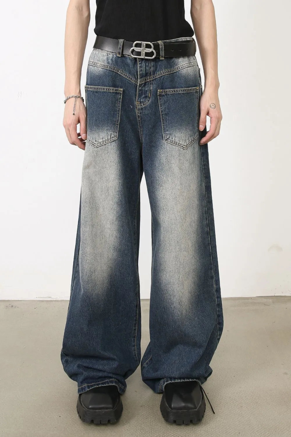 Faded wash palazzo jeans in medium blue denim with a wide leg and distressed details.